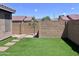 Backyard featuring artificial grass and a stone path surrounded by block walls at 6049 S Wilson Dr, Chandler, AZ 85249