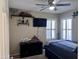 Well lit bedroom with models on shelves and a ceiling fan at 6049 S Wilson Dr, Chandler, AZ 85249