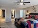 Comfortable bedroom featuring a ceiling fan, a quilted bedspread, and an open closet at 6049 S Wilson Dr, Chandler, AZ 85249