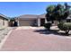 Attractive single-story home with a red brick driveway and mature landscaping at 6049 S Wilson Dr, Chandler, AZ 85249