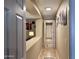 Hallway with tile flooring and natural light, connecting the living spaces and bedrooms at 6049 S Wilson Dr, Chandler, AZ 85249