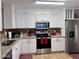 Modern kitchen featuring white cabinetry, stainless steel appliances, and granite countertops at 6049 S Wilson Dr, Chandler, AZ 85249