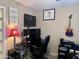 This office features multiple monitors, artwork, and cool guitar decor at 6049 S Wilson Dr, Chandler, AZ 85249
