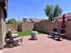Back patio with red brick pavers, outdoor seating, and an umbrella at 6049 S Wilson Dr, Chandler, AZ 85249