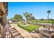 Relaxing backyard features artificial turf, a water feature, and wrought iron fencing with scenic golf course views at 6131 S Bradshaw Way, Chandler, AZ 85249