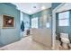 Open bathroom with a glass enclosed shower, modern fixtures, and blue walls creating a spacious and airy design at 6131 S Bradshaw Way, Chandler, AZ 85249