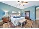 Bright bedroom featuring a comfortable king bed, wooden furniture, and a full bookshelf at 6131 S Bradshaw Way, Chandler, AZ 85249