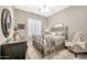 Stylish bedroom featuring a metal bed frame, large windows, and neutral decor, creating a cozy retreat at 6131 S Bradshaw Way, Chandler, AZ 85249