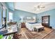 Inviting bedroom offers a king bed, wood floors, a desk area, and an area rug at 6131 S Bradshaw Way, Chandler, AZ 85249