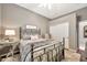 Comfortable bedroom featuring a metal bed frame, neutral decor, and soft lighting, creating a serene retreat at 6131 S Bradshaw Way, Chandler, AZ 85249