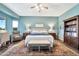 Bright bedroom featuring a comfortable king bed, wooden furniture, and a full bookshelf at 6131 S Bradshaw Way, Chandler, AZ 85249
