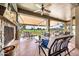 Inviting covered patio with stone fireplace and plush seating overlooking the lush golf course at 6131 S Bradshaw Way, Chandler, AZ 85249