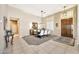 The spacious dining room features modern chandelier, large table with seating for six, and a decorative wood door at 6131 S Bradshaw Way, Chandler, AZ 85249