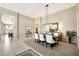 Open-concept dining area featuring tile floors, a modern chandelier, and seating for six around a large table at 6131 S Bradshaw Way, Chandler, AZ 85249