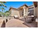 Inviting front porch with wicker furniture, stone accents, and an attractive entrance at 6131 S Bradshaw Way, Chandler, AZ 85249