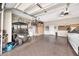 Organized garage featuring a golf cart, hanging bikes, storage cabinets, and epoxy flooring at 6131 S Bradshaw Way, Chandler, AZ 85249
