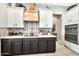 Modern kitchen featuring stainless steel appliances, tile backsplash, white cabinets, and under cabinet lighting at 6131 S Bradshaw Way, Chandler, AZ 85249