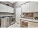 Well-organized laundry room with modern washer and dryer, ample cabinet space, and a functional countertop at 6131 S Bradshaw Way, Chandler, AZ 85249