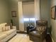 Inviting living area with a comfy chair, couch, and natural light from the nearby window at 6131 S Bradshaw Way, Chandler, AZ 85249