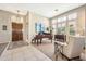 Open-concept living room with tile flooring, a decorative wooden door, and a baby grand piano at 6131 S Bradshaw Way, Chandler, AZ 85249