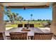 Covered patio with an outdoor dining area featuring scenic views of the backyard, landscaping, and golf course at 6131 S Bradshaw Way, Chandler, AZ 85249