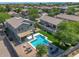 Backyard with a sparkling pool, covered patio, and brick paved seating area, ideal for outdoor enjoyment at 6321 W Gross Ave, Phoenix, AZ 85043