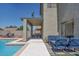 Covered patio for outdoor dining in a backyard with a pool and ample seating at 6321 W Gross Ave, Phoenix, AZ 85043