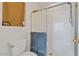 This clean bathroom features a glass enclosed shower and white tiled walls at 6321 W Gross Ave, Phoenix, AZ 85043
