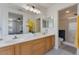 Bright bathroom with double sinks, granite counters, and updated fixtures with tile flooring at 6321 W Gross Ave, Phoenix, AZ 85043