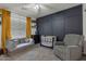 Inviting room featuring a cozy seating area, stylish crib, and modern accent wall at 6321 W Gross Ave, Phoenix, AZ 85043
