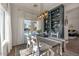 Bright dining room with pool views, modern light fixture, and built-in shelving at 6321 W Gross Ave, Phoenix, AZ 85043