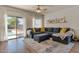 Inviting living room featuring a large sectional sofa, stylish rug, and access to the backyard pool at 6321 W Gross Ave, Phoenix, AZ 85043