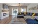 Cozy living room boasts a fireplace, large sectional sofa, and views of the pool area at 6321 W Gross Ave, Phoenix, AZ 85043