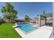 Stunning backyard featuring a refreshing pool, lush landscaping, and a relaxing lounge area at 6321 W Gross Ave, Phoenix, AZ 85043