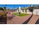 Spacious backyard featuring a lush lawn, mature palm trees, and a well-maintained patio area at 643 W Medina Ave, Mesa, AZ 85210