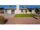 Spacious backyard featuring a lush lawn, mature palm trees, and a well-maintained patio area at 643 W Medina Ave, Mesa, AZ 85210