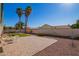 Spacious backyard featuring a lush lawn, mature palm trees, and a well-maintained patio area at 643 W Medina Ave, Mesa, AZ 85210