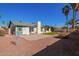 Spacious backyard featuring a lush lawn, mature palm trees, and a well-maintained patio area at 643 W Medina Ave, Mesa, AZ 85210