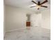Bedroom with ensuite bathroom features neutral walls, ceiling fan, and marble flooring at 643 W Medina Ave, Mesa, AZ 85210