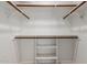Walk-in closet with shelving and wooden rods for ample storage at 643 W Medina Ave, Mesa, AZ 85210