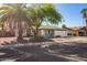 Charming single-Gathering home with a two-car garage, front yard landscaping, and mature shade trees at 643 W Medina Ave, Mesa, AZ 85210