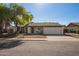 Charming single-Gathering home with a two-car garage, front yard landscaping, and mature shade trees at 643 W Medina Ave, Mesa, AZ 85210
