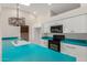 Bright kitchen features a skylight, white cabinets, and turquoise countertops at 643 W Medina Ave, Mesa, AZ 85210