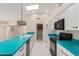Bright kitchen features a skylight, white cabinets, and turquoise countertops at 643 W Medina Ave, Mesa, AZ 85210