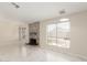 Living room with brick fireplace, white marble floors, and built-in shelves at 643 W Medina Ave, Mesa, AZ 85210