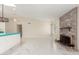 Bright living room featuring a brick fireplace, white marble floors, and modern lighting at 643 W Medina Ave, Mesa, AZ 85210