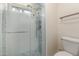 Bathroom with a glass enclosed shower with blue tile accent at 643 W Medina Ave, Mesa, AZ 85210