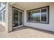 A covered outdoor patio featuring a brick paved area, a sliding glass door, and a window at 644 N Vine St, Chandler, AZ 85225