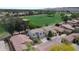 Community aerial view showcasing residential properties adjacent to a lush golf course with manicured greens and scenic views at 7029 S Golfside Ln, Phoenix, AZ 85042