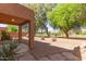 Back yard with covered patio and desert landscaping at 7029 S Golfside Ln, Phoenix, AZ 85042